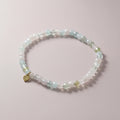 The Mermaid's Den Astilbe Morganite beaded bracelet with soft blush and peach gradient gemstones and a gold heart charm