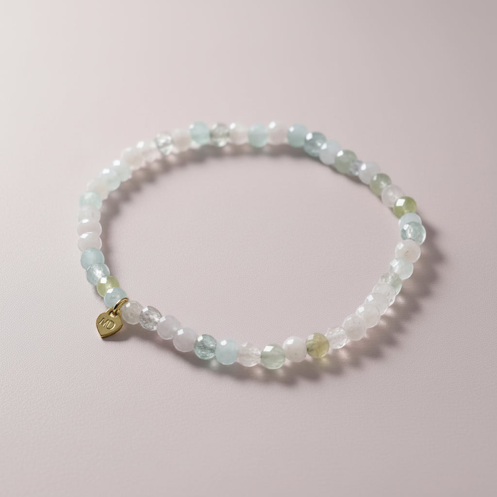 The Mermaid's Den Astilbe Morganite beaded bracelet with soft blush and peach gradient gemstones and a gold heart charm