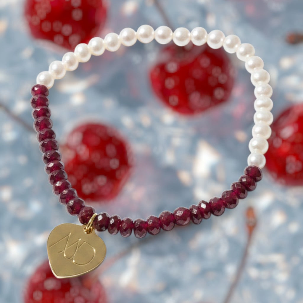 The Mermaid's Den Gloriosa Red Corundum and freshwater pearl beaded bracelet with a gold heart charm.